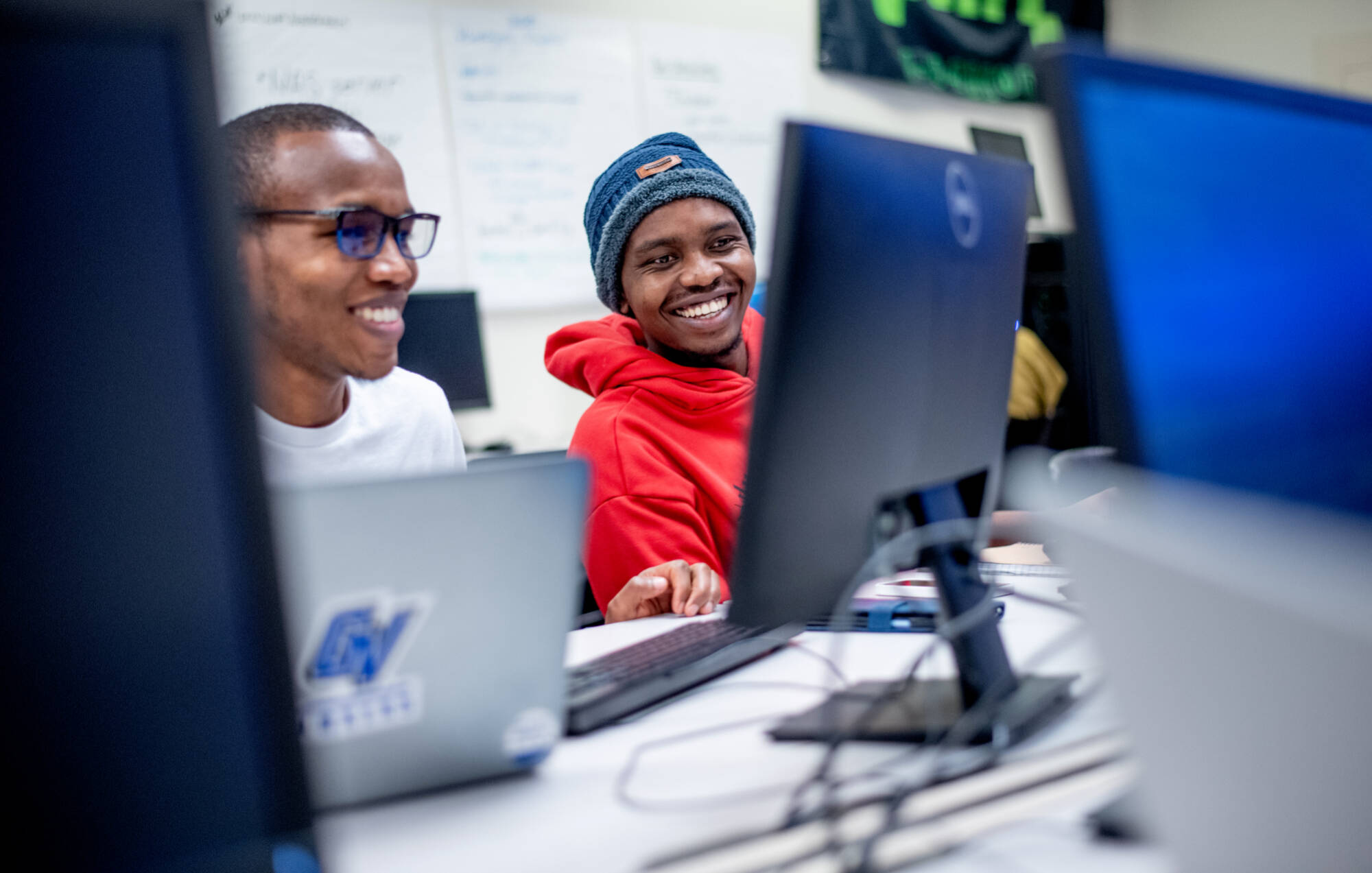 Two students working on a computer.